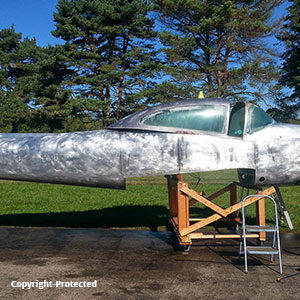 side view of navion airplane being restored no paint